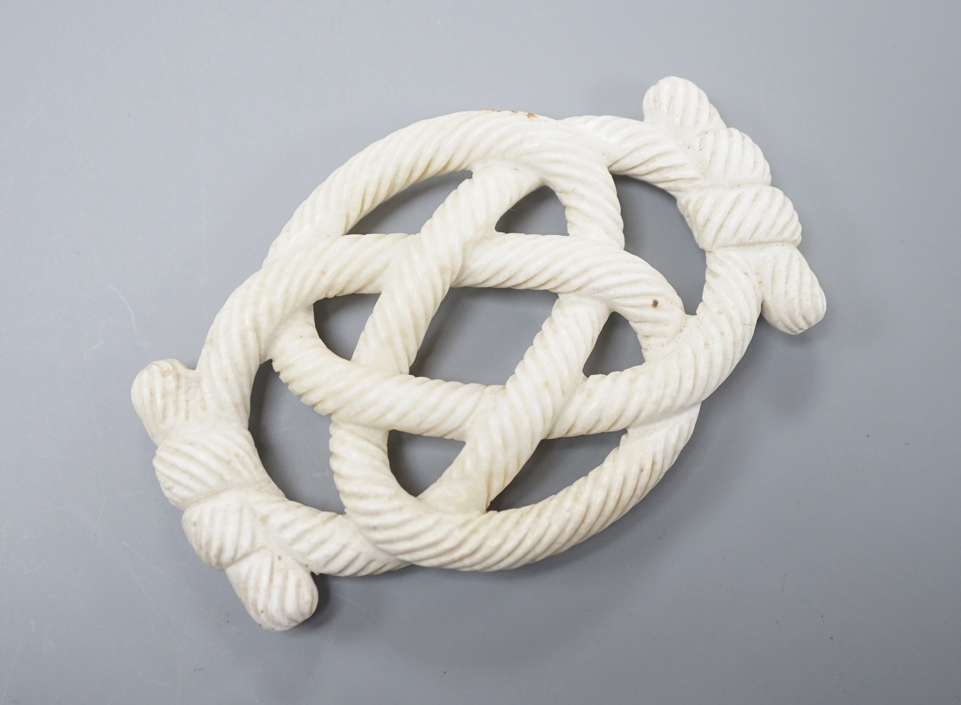 A Chinese hardstone eternal knot carving, 19th century, possibly burnt jade, 8.4cm